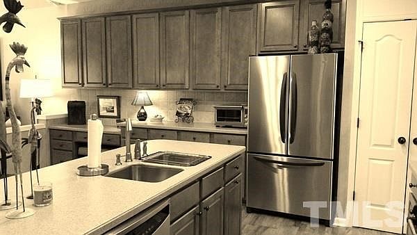 Custom Cabinets 42" with Tile Backsplash, Corian Countertops, Eat-in-Kitchen, Hardwood floors, Double Door Pantry, upgraded oil rubbed bronze egg door knobs, and plenty of cabinets!