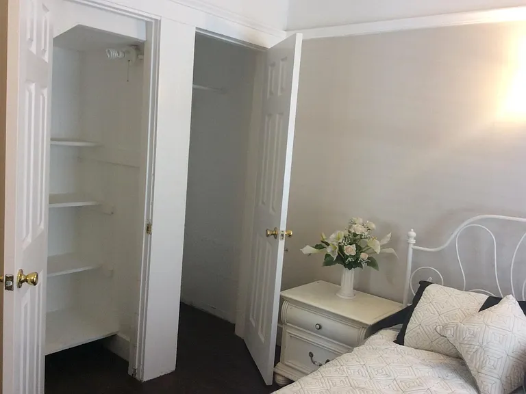 Third bedroom downstairs showing two closets (decor different).