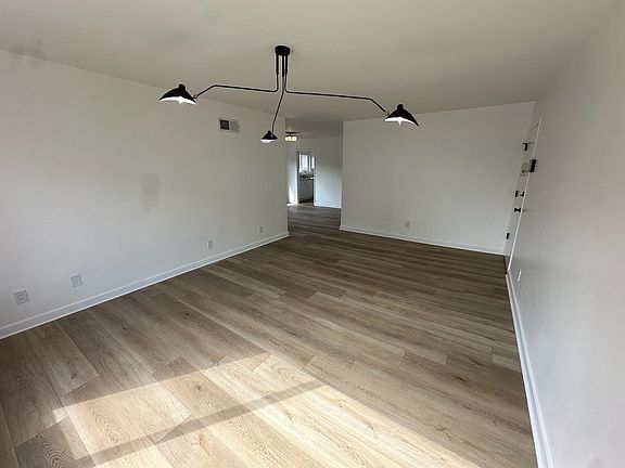 Living Room - Fully Renovated - View 2 - New Floors, Paint, Light Fixture, Removed popcorn ceiling. Amazing light