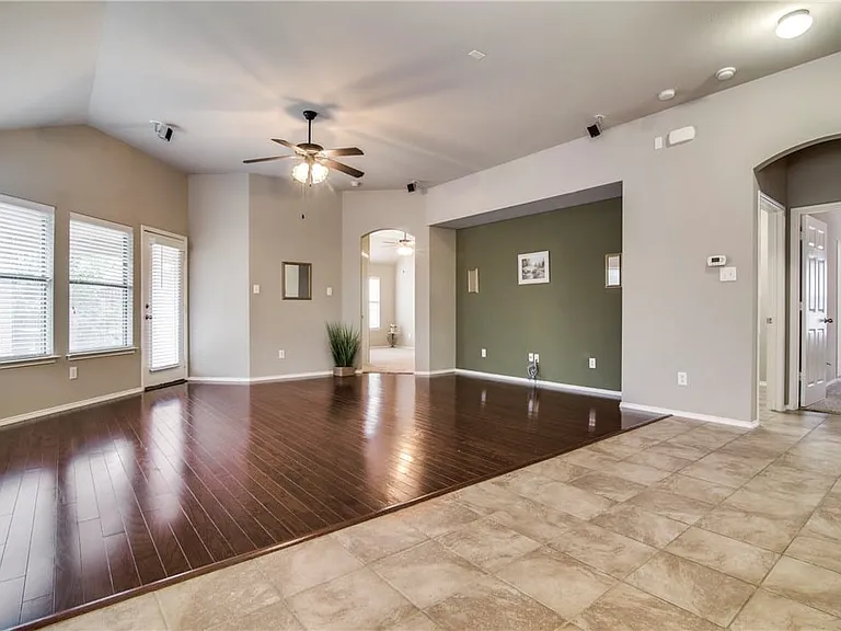 Wood floors in living room with master separate from secondary bedrooms.