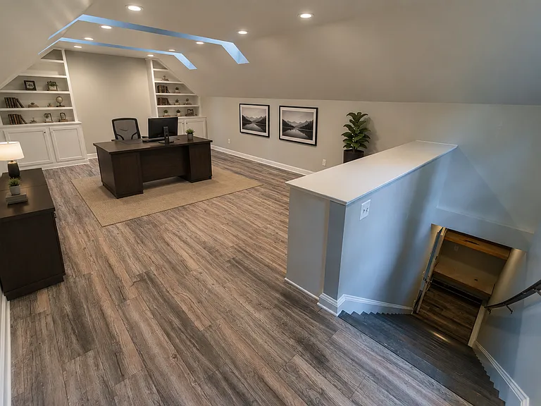 Finished room over the 3-car garage. This multi-purpose room is very large and includes skylights and custom built-in bookshelves and cabinets.