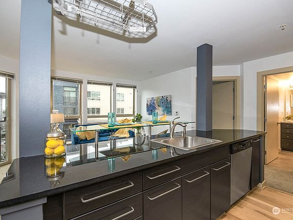 Lots of storage in the kitchen along with beautiful quartz counters, stainless steel appliances and hardwood flooring.>
