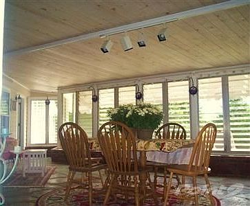 Inviting Family/Sun-room. beadboard ceiling, fieldstone floors & glassed walls. Leads to rear Patio.