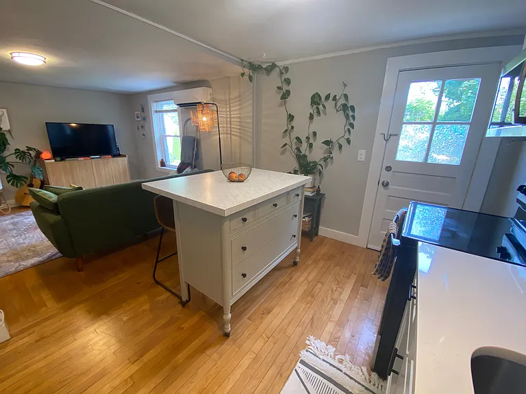 Kitchen door to exterior set of stairs that leads to backyard.