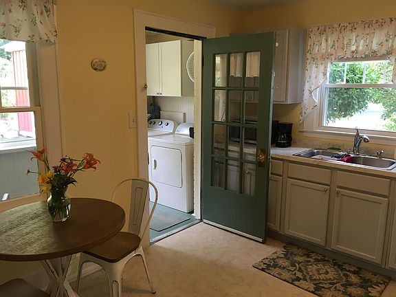 Kitchen with screened in porch with washer and dryer. There is no dish washer except you