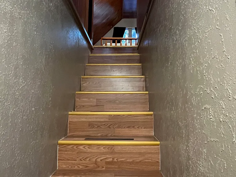 Stairs up to bedroom above garage