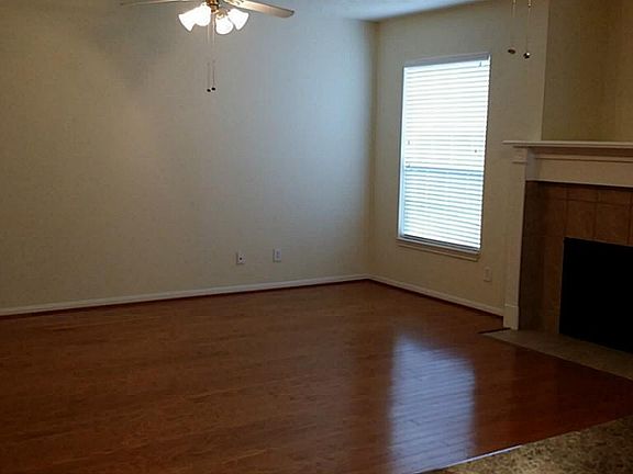 Spacious living room w/ wood flooring