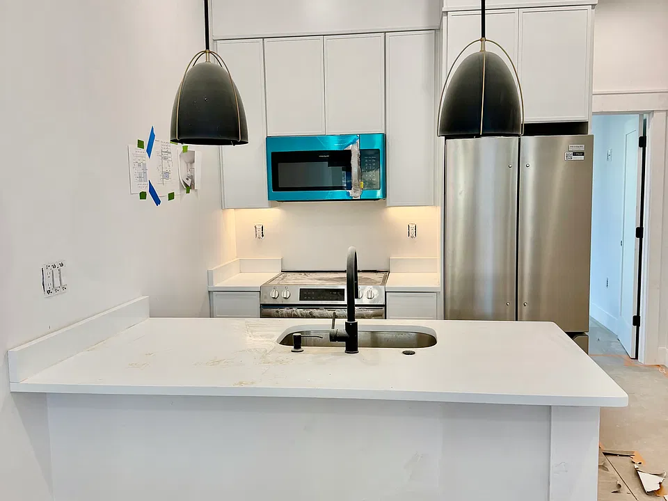 Example of unit 2 kitchen. Same finishes upstairs different lights (island and fridge may be larger upstairs in the penthouse unit)