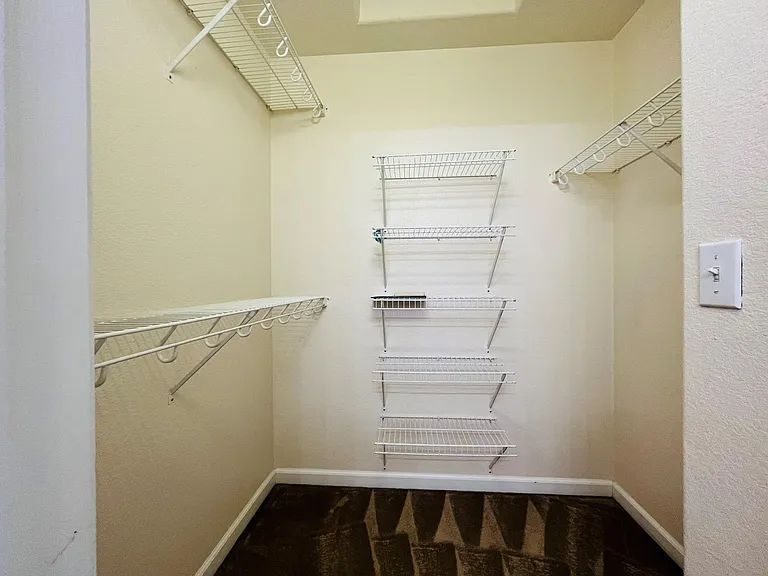 Beautiful spacious master bedroom with vaulted ceilings, large windows, large walk-in closet with custom shelving. Master bathroom with his and her sinks, spacious bathtub, linen closet