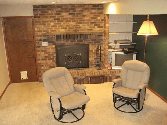 welcoming family room area with wood burning fireplace