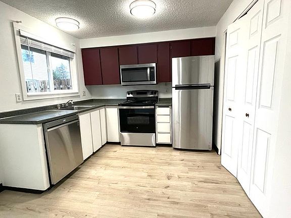 Kitchen with brand new stainless steel appliances(Refrigerator, Microwave, range and dish washer