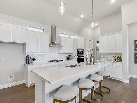 Kitchen in the Pinot home plan by Trophy Signature Homes - REPRESENTATIVE PHOTO