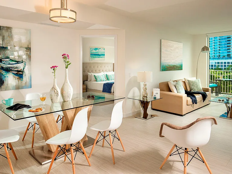 Open living and dining layout with access to a private balcony