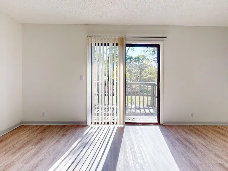 Enjoy abundant natural light in this spacious living area with balcony access.