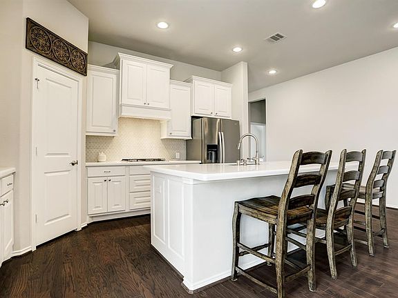 Large Island kitchen with quartz countertops.