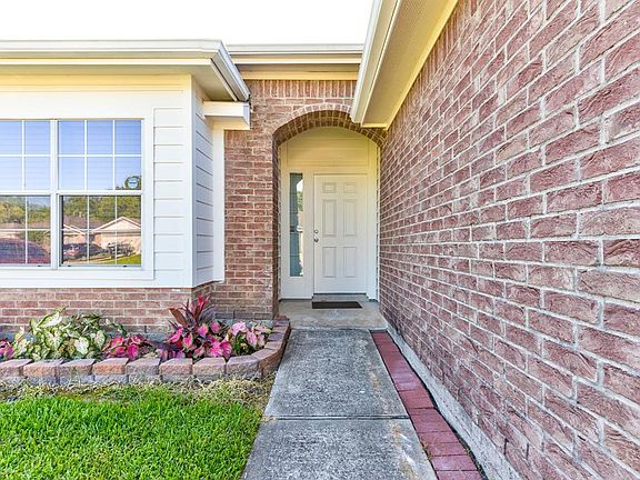 Welcoming entrance. Nice flower bed greets you.