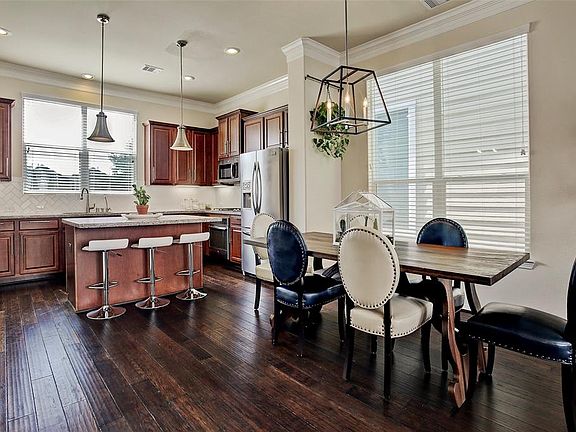 Dining area has large, bright windows and a modern up-graded light fixture.