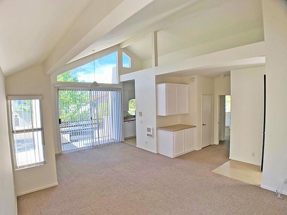 Living Room facing westward great views and sunsets, 20foot vaulted ceilings, storage cabinets and closet