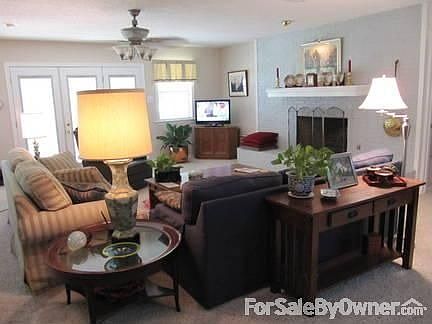 Living Room : Open space connecting to dining room with large fireplace and lake views.