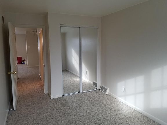 2nd bedroom closet with full mirrors
