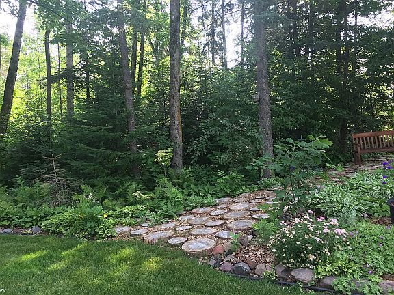 Woodland path to boathouse .