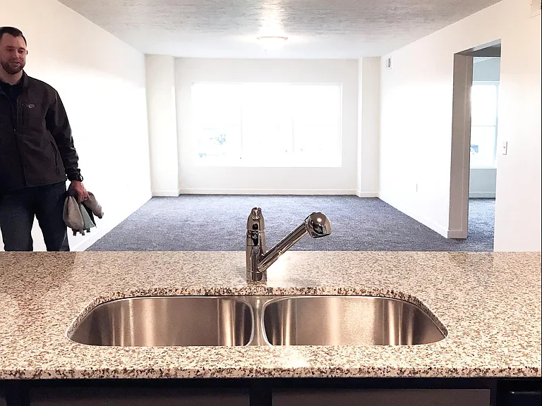 Kitchen flows into living room with large window