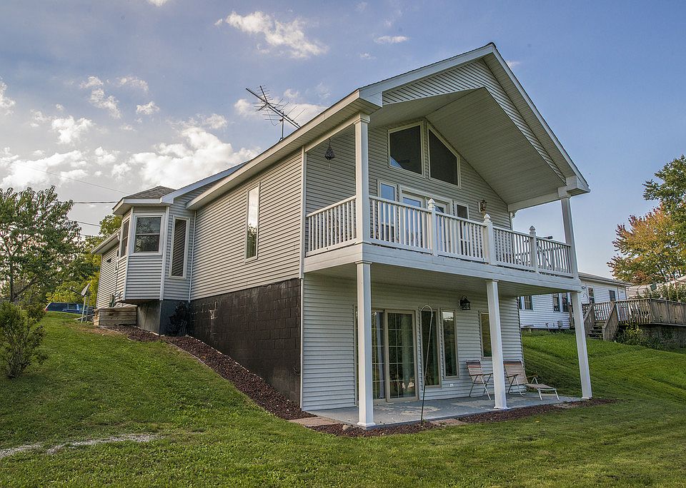 SUNRISES ON SANFORD LAKE! Take a look at this recently constructed lakefront home with eastern exposure featuring 4 bedrooms, 2 bathrooms and approximately 2,000 square feet with a walk out lower level currently set up as a two unit dwelling with an open concept layout. Live in the top and rent out the bottom or keep both sides for yourself! Lots of opportunities with this beautiful home built in 2010. Each level is fully equipped with a full bathroom and a kitchen, and each unit has a patio view of Sanford Lake. Features include: tile flooring, vaulted ceilings, skylights, high efficiency utilities and more. Don't wait, call today for your own private showing!