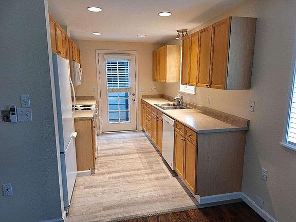 Galley kitchen complete with all appliances and covered access to garage