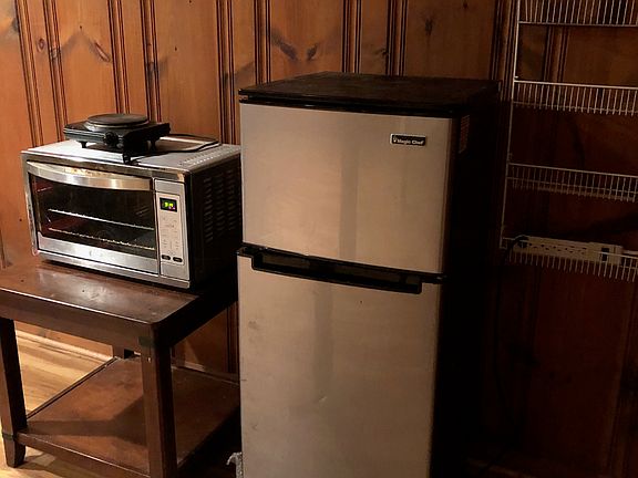 I currently have a small fridge and a convection oven. The tenants in the past had a hot plate, a microwave, and a toaster oven. I have a large freezer that you can use, too.