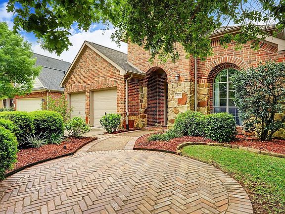Beautiful elevation and has extra bricked patio to enjoy with view of green space/park.