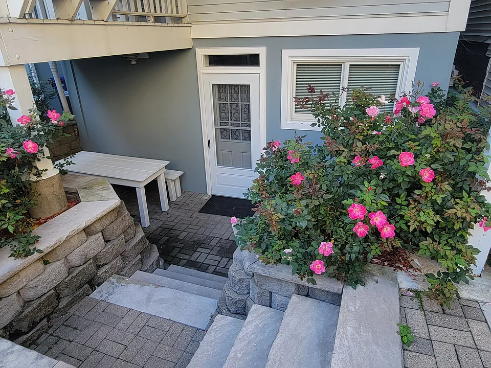 Enjoy your own private patio surrounded by beautiful seasonal flowers _ a perfect spot to relax or enjoy your morning coffee.