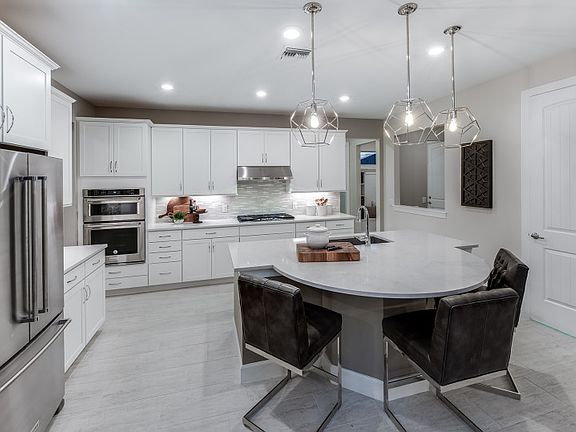 Model Representation Gourmet kitchen with white maple cabinets stainless steel gas appliances