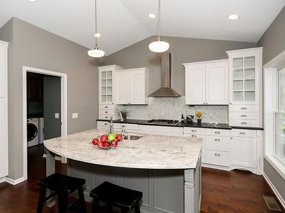Stunning kitchen offers all you would expect in a high end build. Granite, stainless, hardwood floors and tile backsplash.