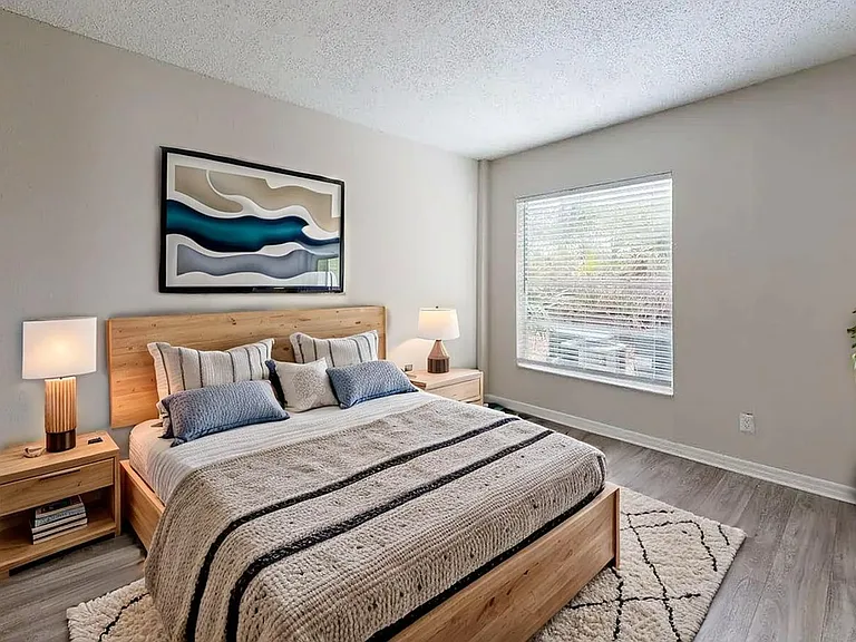 Inviting bedroom with modern decor, featuring a cozy wooden bed, stylish lamps, and a large window for natural light. Inviting bedroom with modern decor, featuring a cozy wooden bed, stylish lamps, and a large window for natural light.