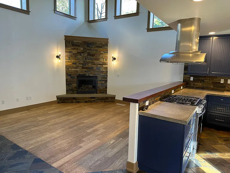 View of living room and kitchen when entering from garage door