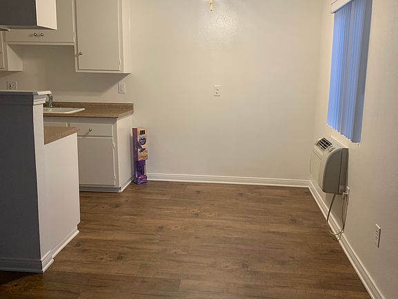 Flooring in kitchen, living room, and table area.