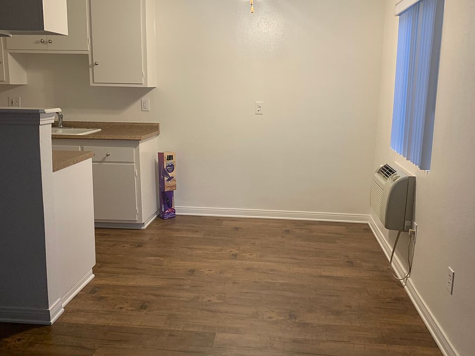 Flooring in kitchen, living room, and table area.