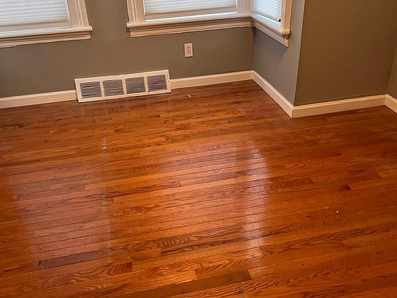 Spacious bedroom with new light fixture and hardwood floor
