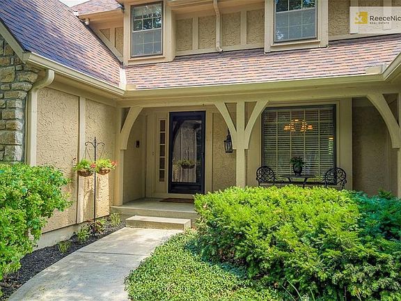 Welcoming front porch leads to beautifully finished interior.