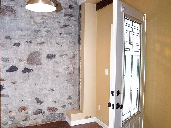 Classic stone entryway serves as an ante-room, office space, or sitting area.