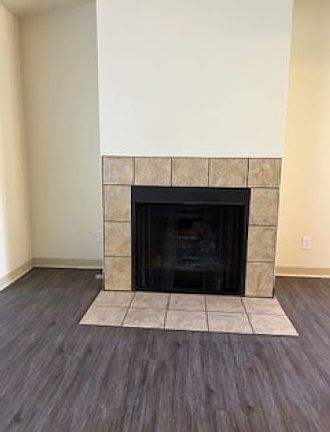 Wood-burning fireplace with upgraded tiles and hearth