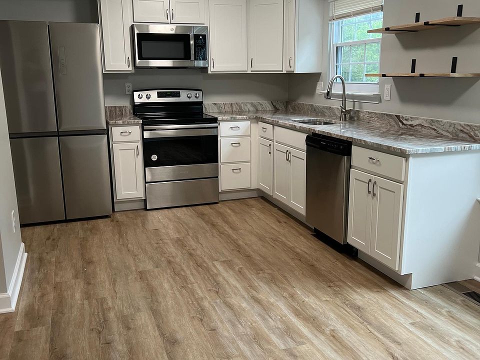 New kitchen with new stainless steel appliances and granite countertops.