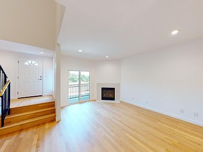 Living room with fireplace and patio door.