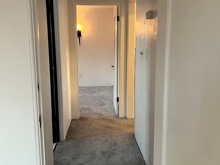 hallway between bedrooms and bathroom
