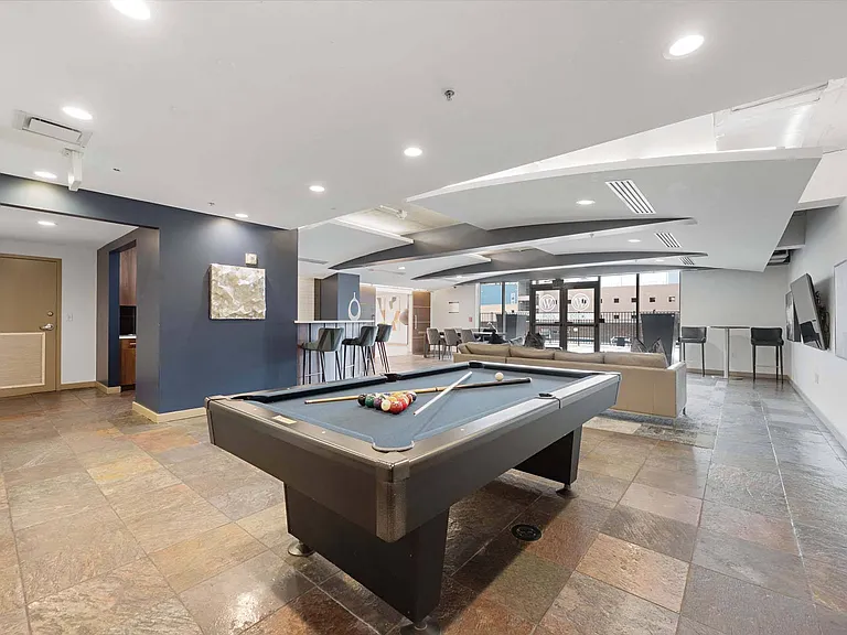 Play and unwind in our stylish lounge featuring a fun pool table for endless entertainment.