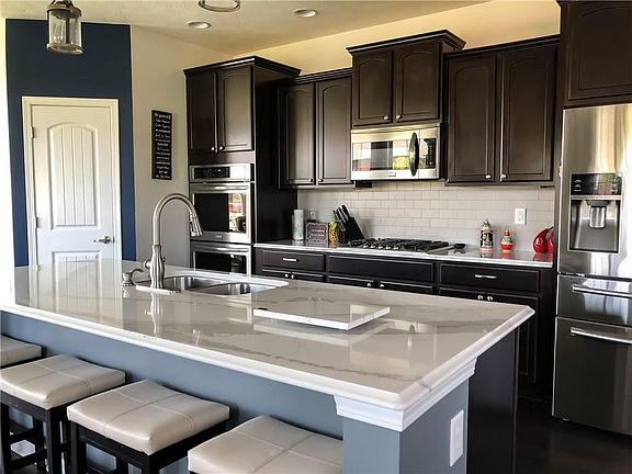 Large kitchen island w/quartz countertop.