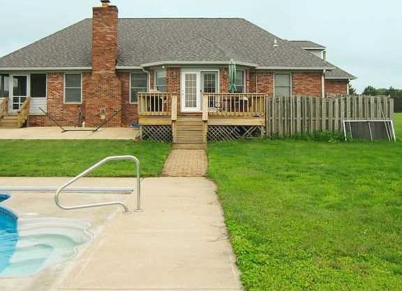Exterior Back. Concrete patio on both sides of deck.