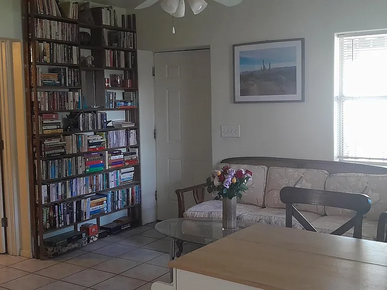 Living room/kitchen combo. Books, games, puzzles. Dining counter with 2 bar stools.