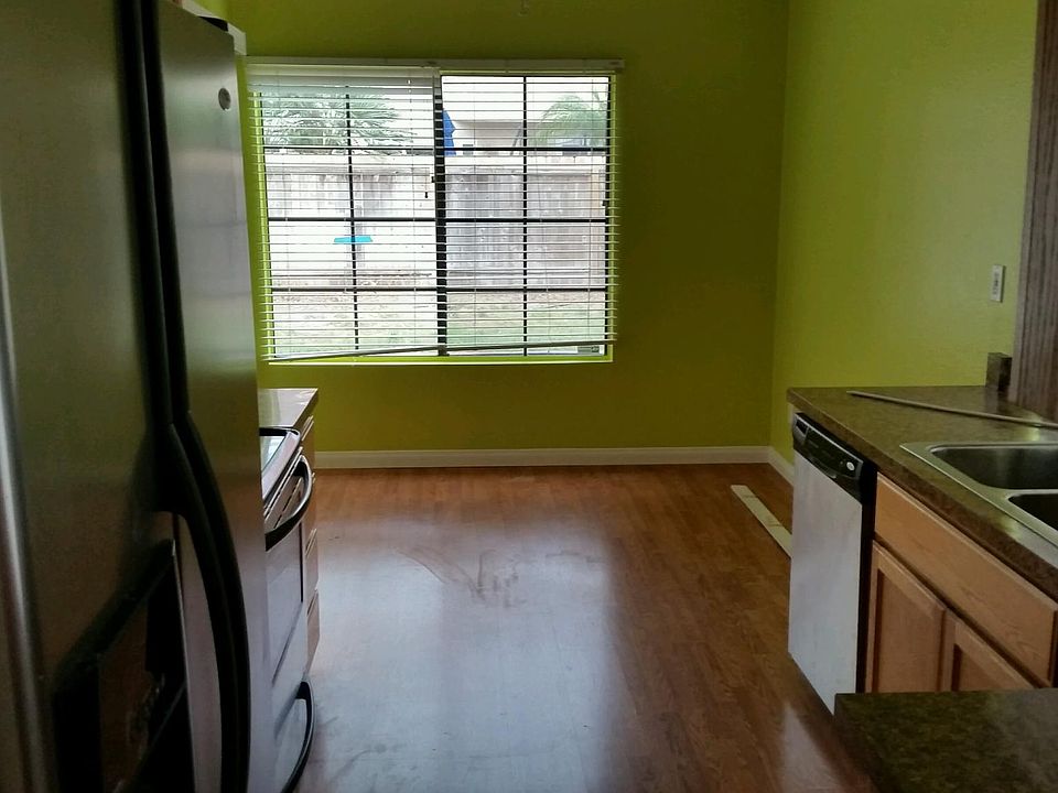 Stainless kitchen with dining area. Slider to patio/yard.
