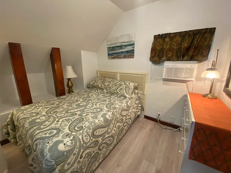 Double bed with gel foam mattress, and chest of drawers in bedroom area.